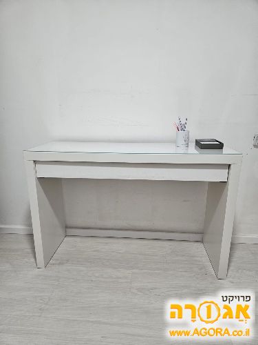 שולחן כתיבה עם זכוכית מונחת על השולחן